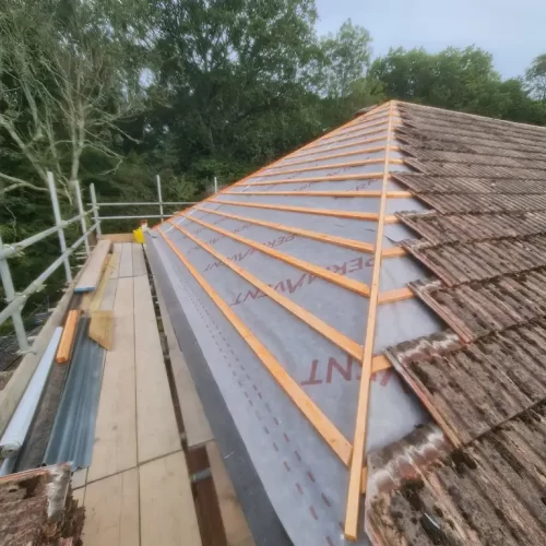 A photo illustrating a half-way done re-roofing project